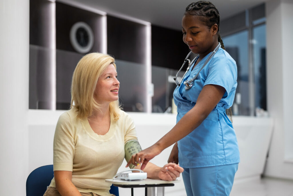 A nurse monitoring a patient's blood pressure